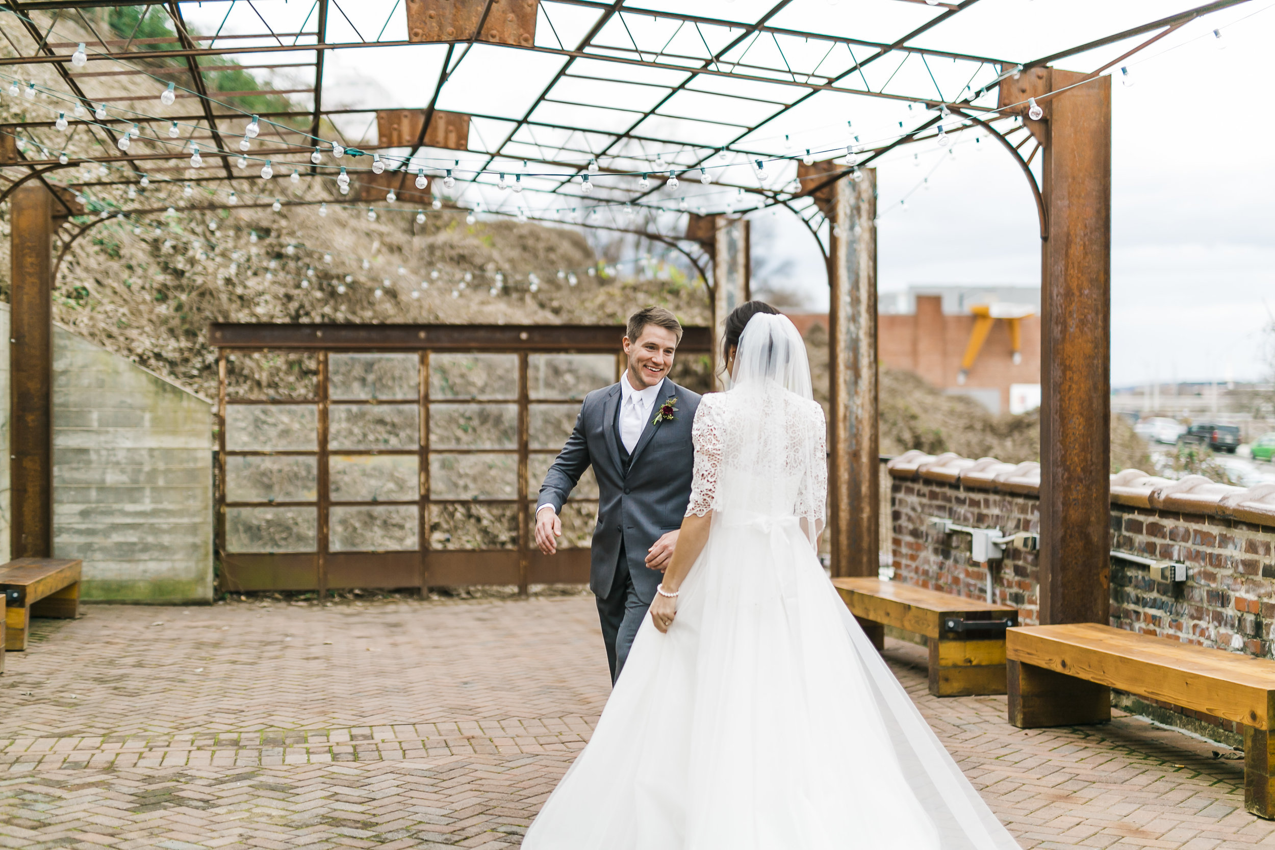bride and groom first look winter wedding outdoors on patio of the standard downtown knoxville