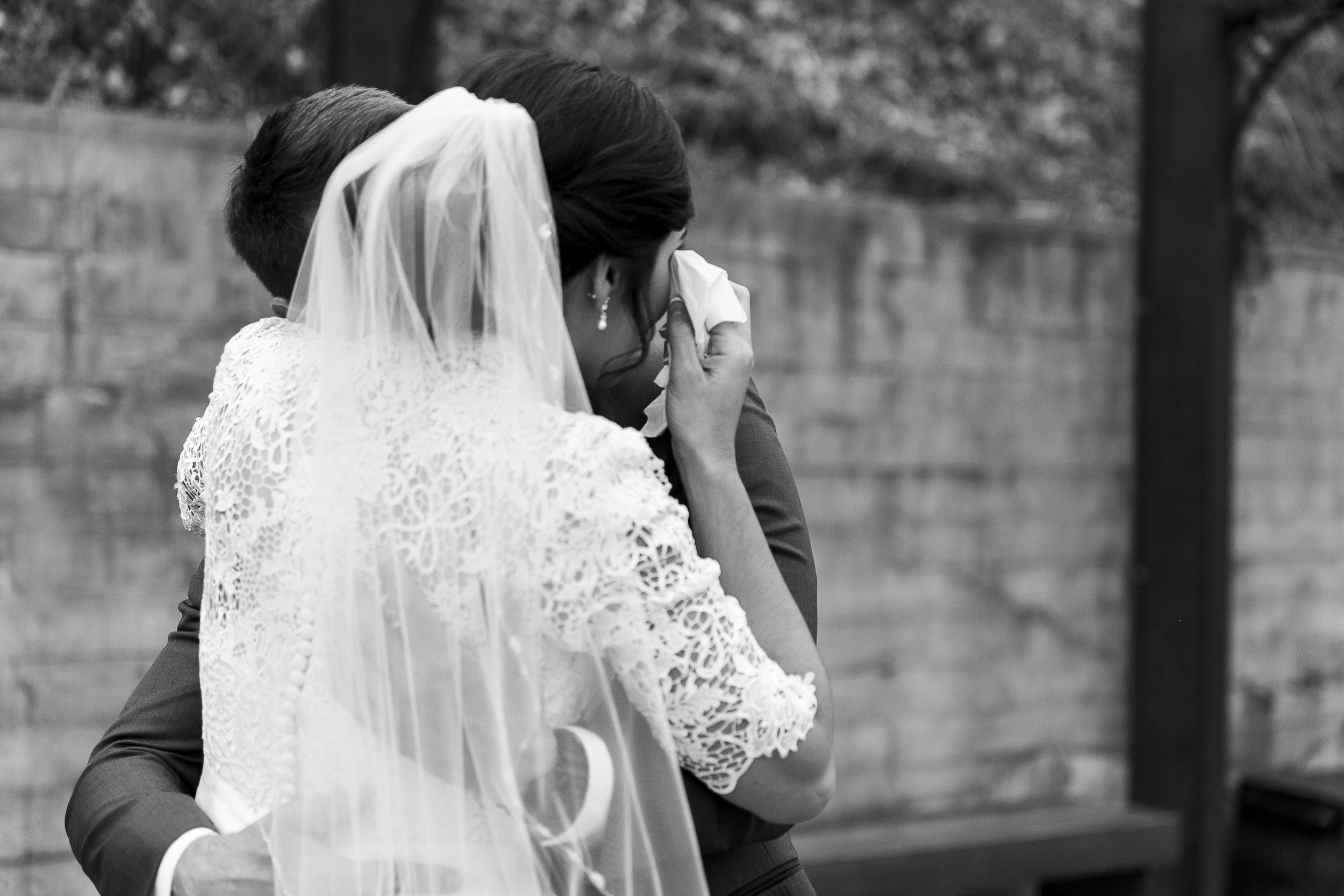 black and white of bride and groom first look bride crying