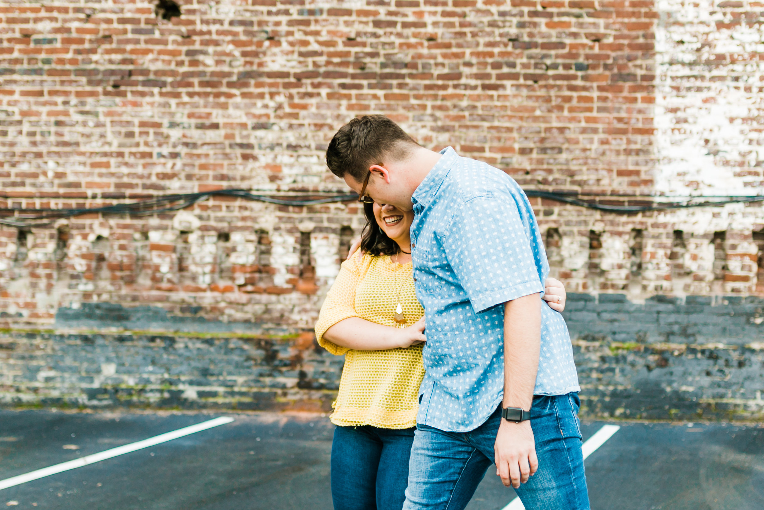 yellow and blue engagement session colors walking in parking lot downtown knoxville