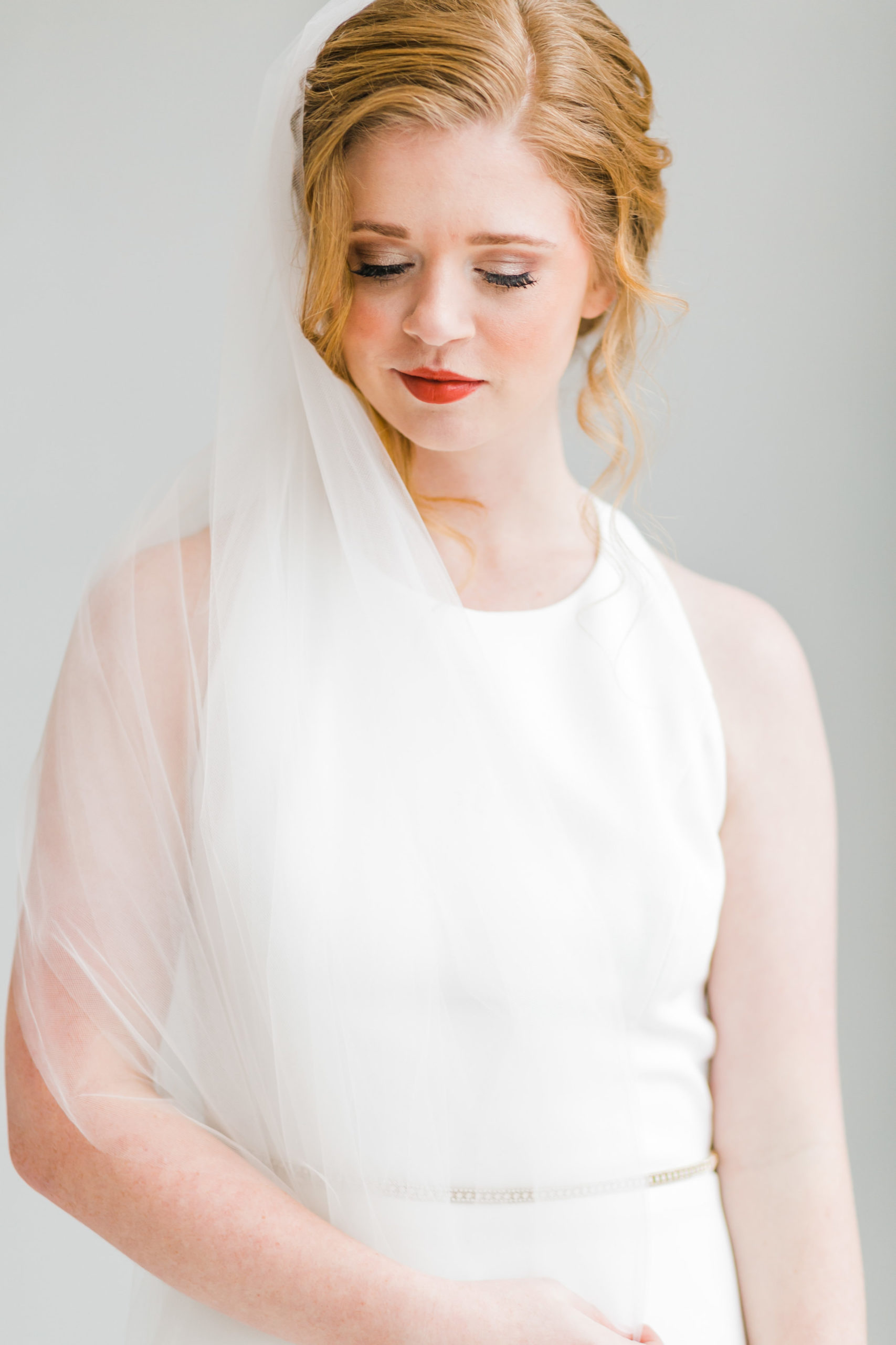 classic red head bride with unembellished dress pronovias and veil