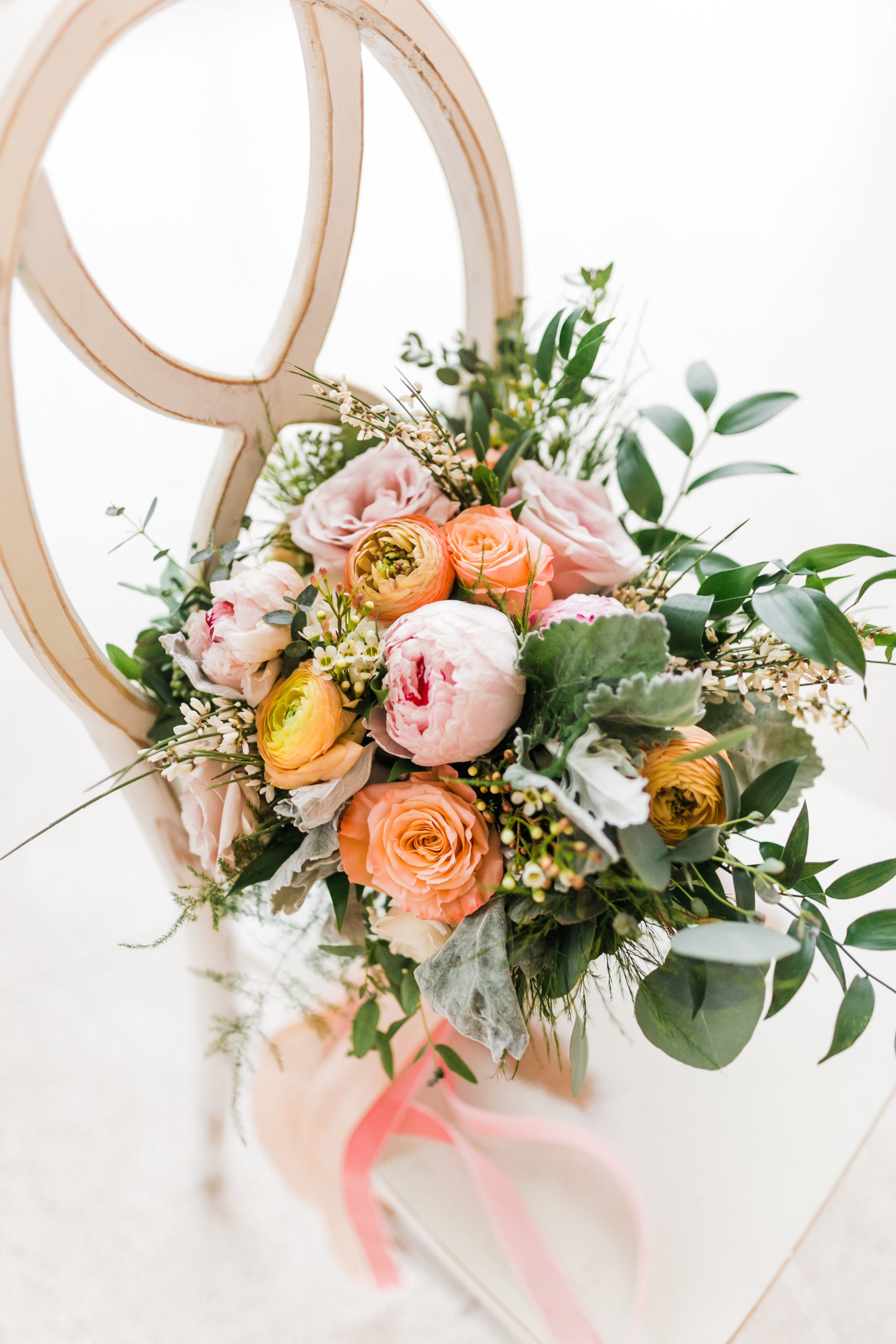 spring bouquet with peony and rannuculus and roses in pink and orange
