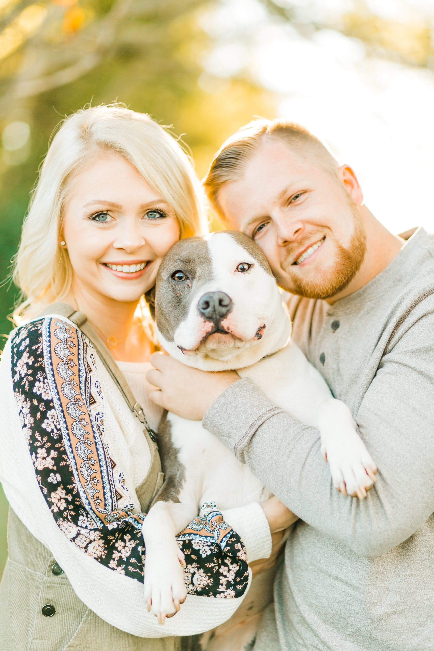 young couple with cute pitbull engagement photos