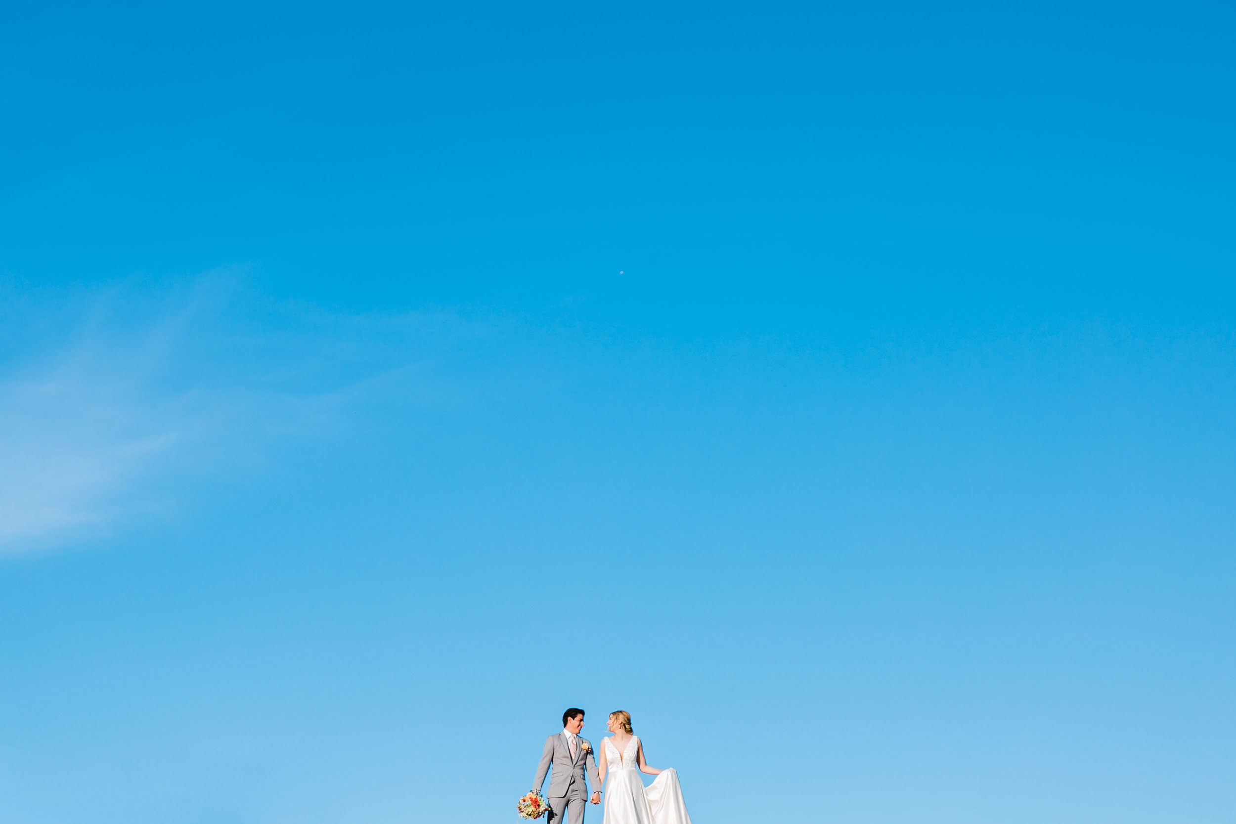 big blue skies and wedding couple full sun maypop fields east tn wedding venue