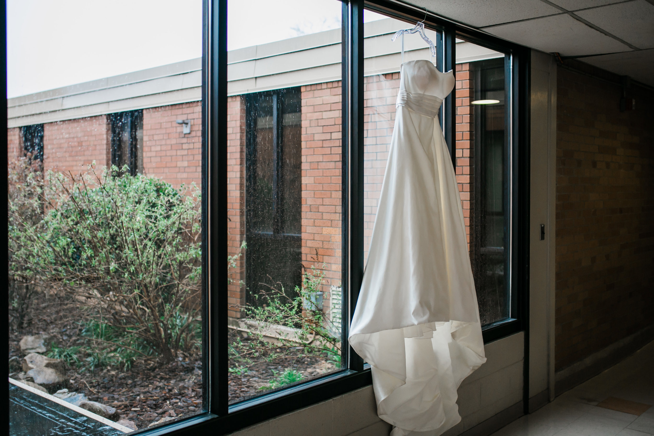 wedding dress hanging in window at concord united Methodist church in Knoxville tn 