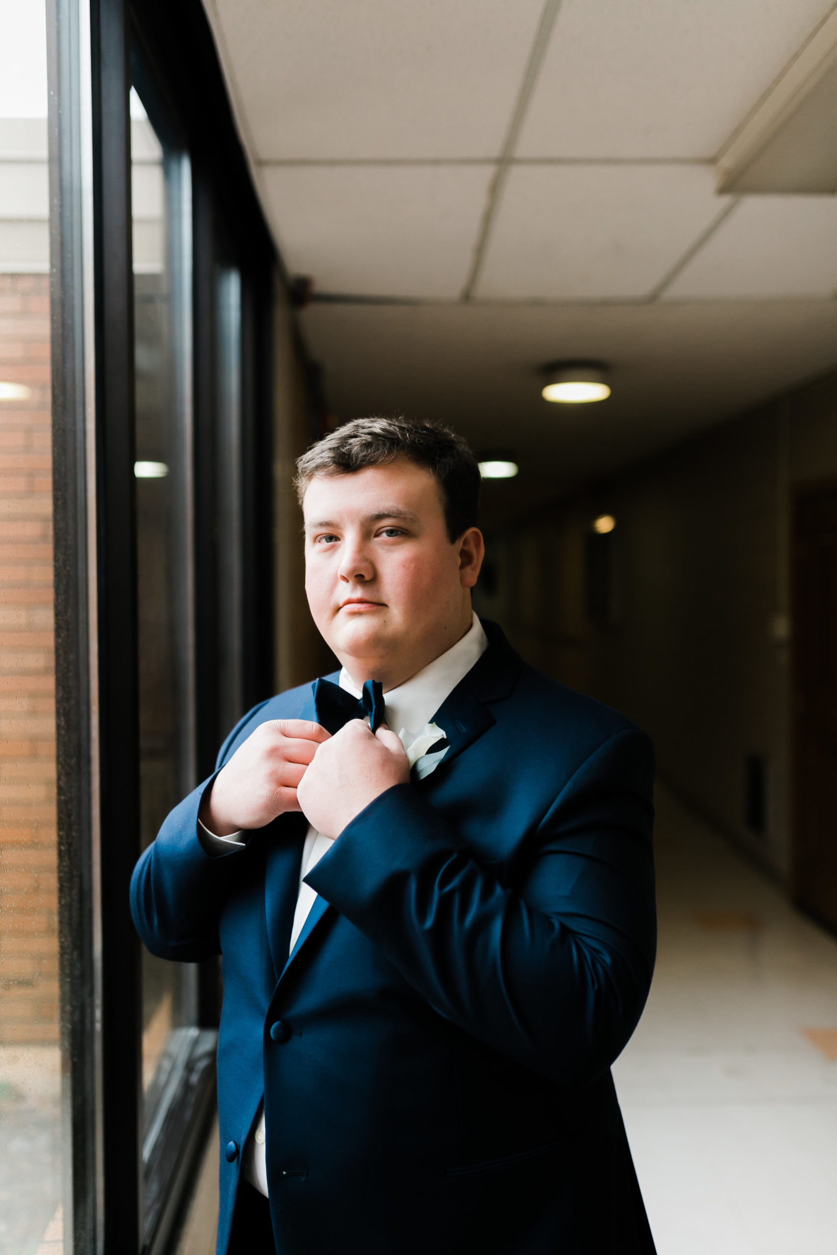 concord united methodist groom blue suit hallway wedding