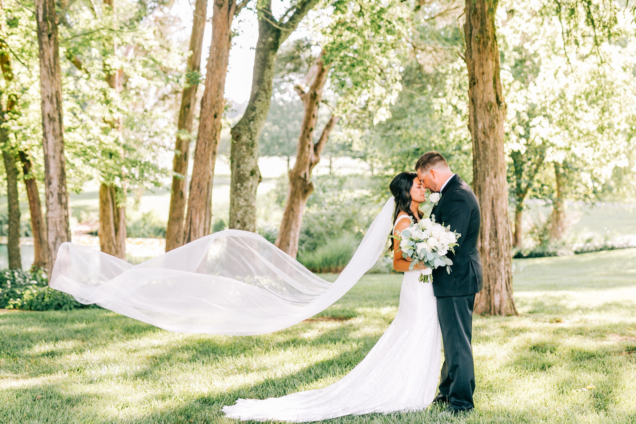 couple standing with veil at marblegate farm