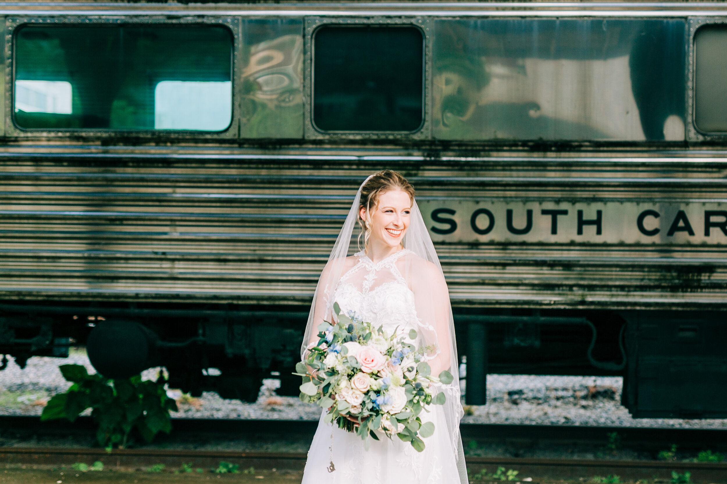 bride in front of train at the southern railway station